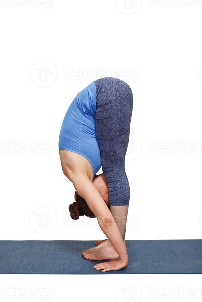 Woman doing yoga asana Uttanasana   standing forward bend photo