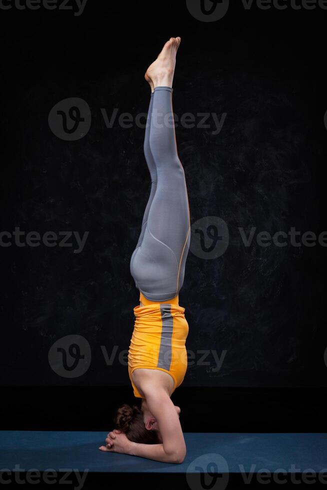 Yoga - woman doing yoga asana sirsana photo