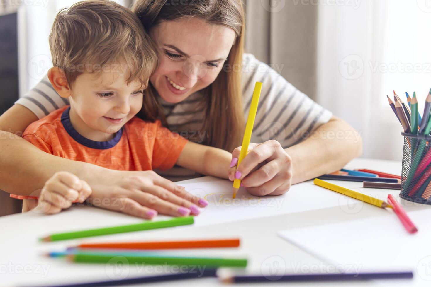 Mother and Son Enjoying Creative Time with Pencils photo