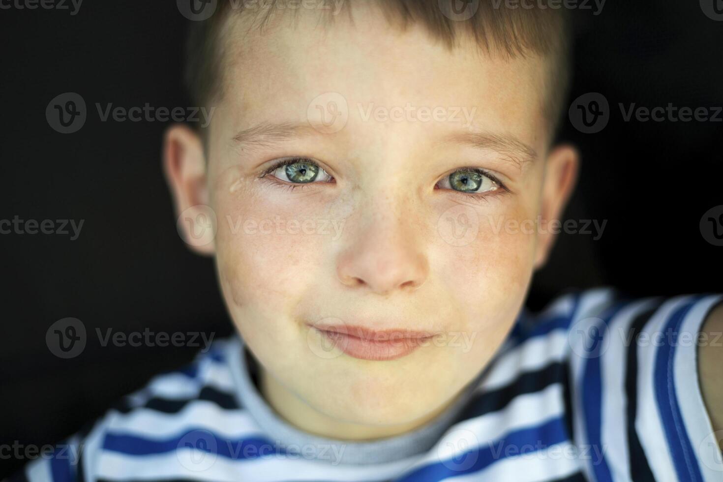 Sad little child is crying. Closeup portrait of a crying boy photo