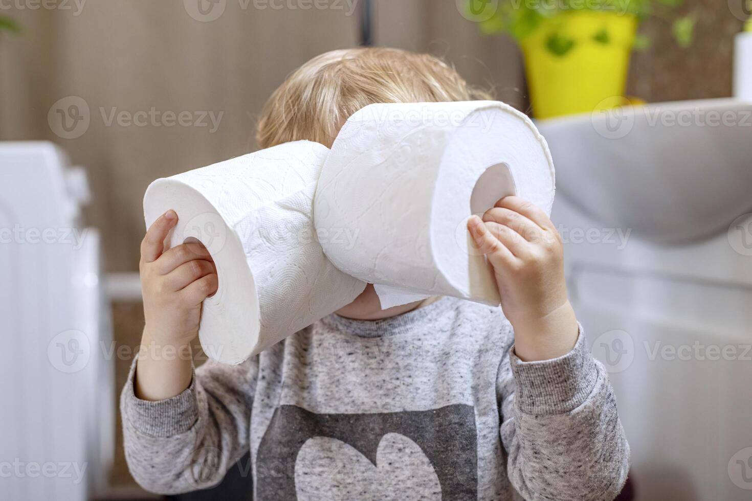 Child Playing with Toilet Paper Rolls photo