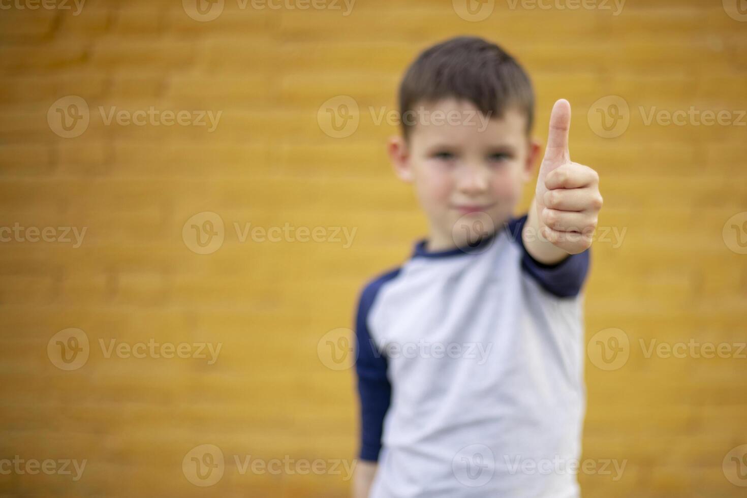 Boy Giving Thumbs Up to Camera photo