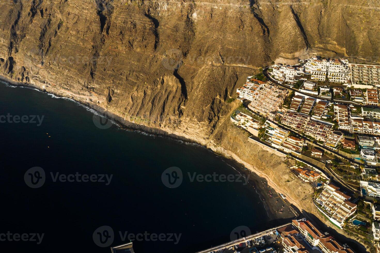 Top view of the houses located on the rock of Los Gigantes at sunset, Tenerife, Canary Islands, Spain photo