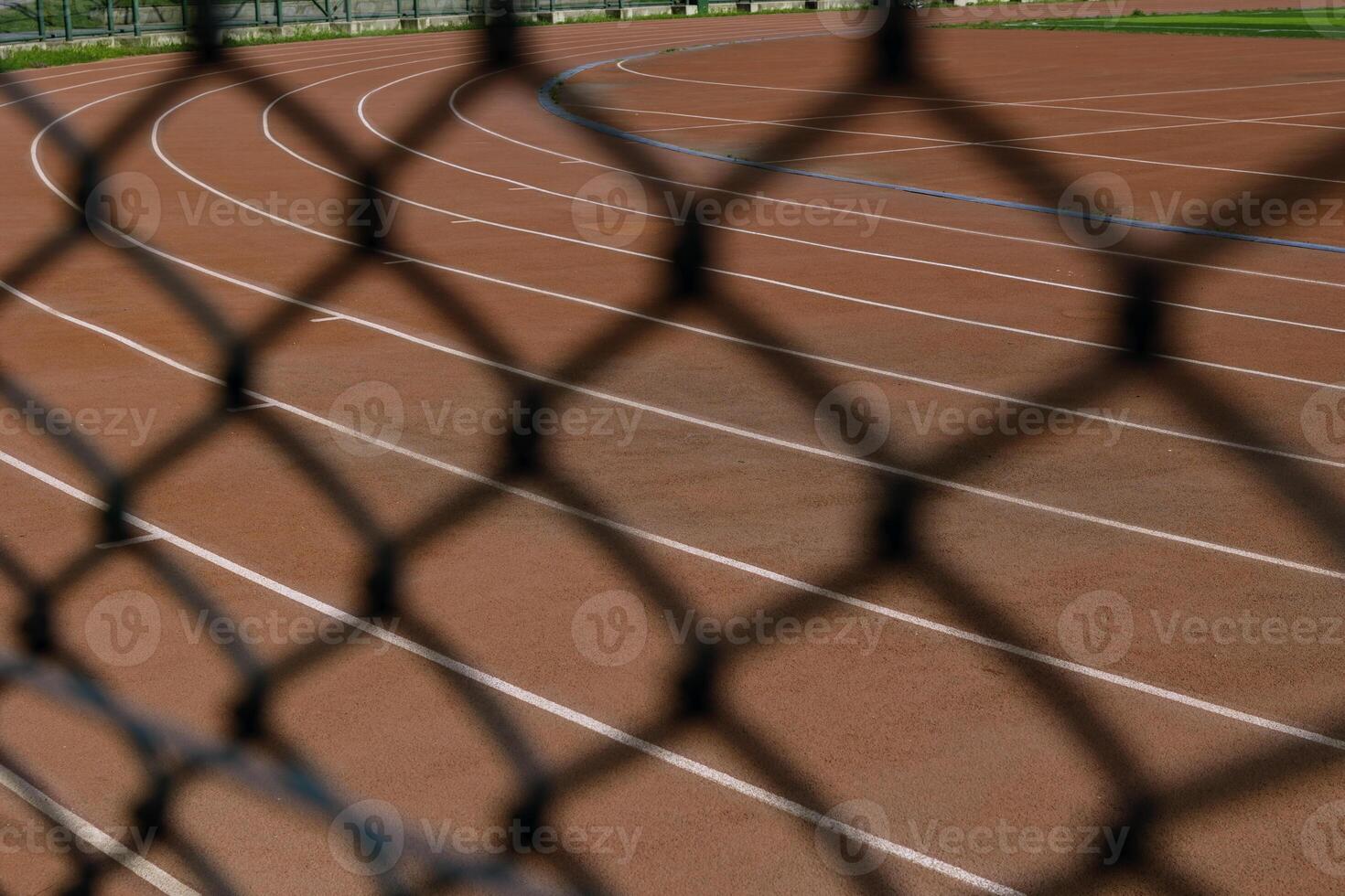 Running tracks behind the fences. Sport background photo. photo
