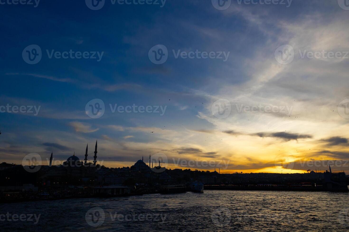 Istanbul silhouette at sunset from a ferry. Cityscape of Istanbul photo
