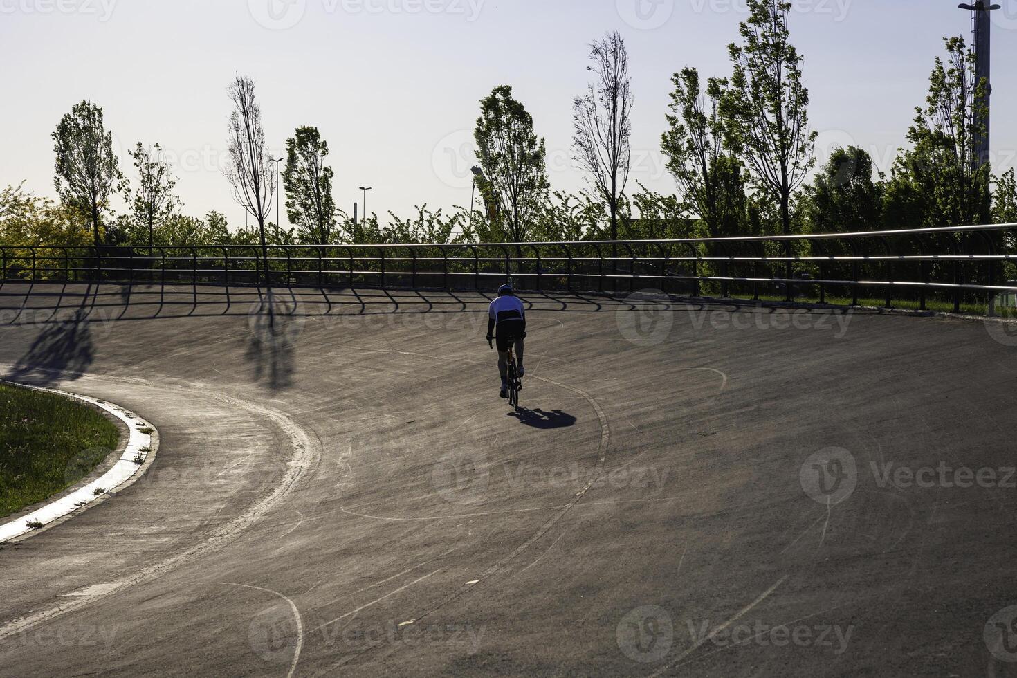 Biker training in the park in a cycle-racing track. Healthy lifestyle concept photo