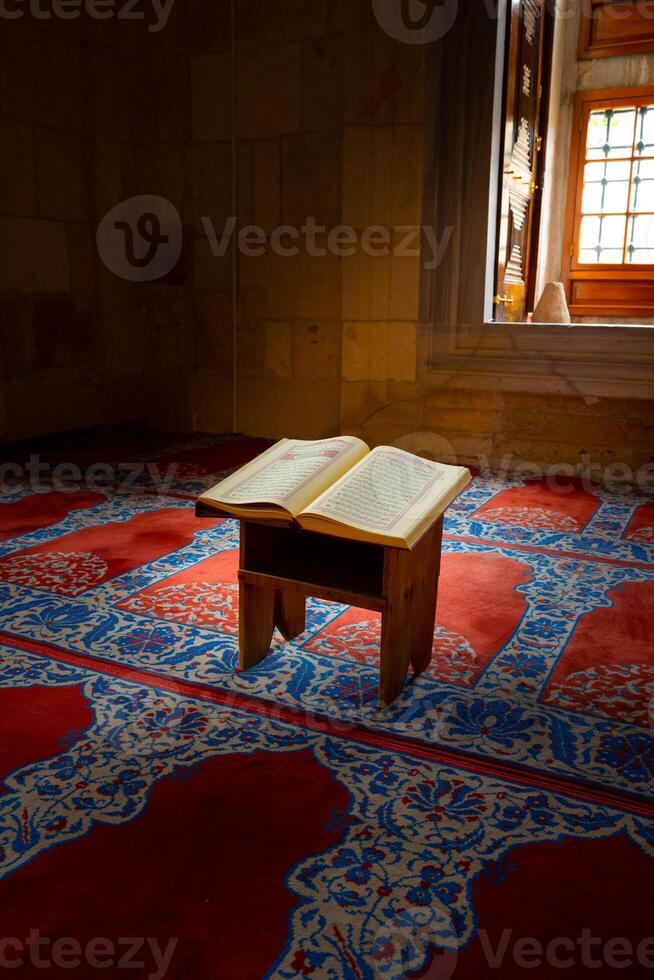 Ramadan or islamic vertical background photo. Holy Quran on the book stand photo