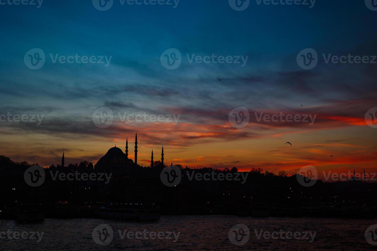 Silhouette of Istanbul with dramatic clouds at sunset. Suleymaniye Mosque photo