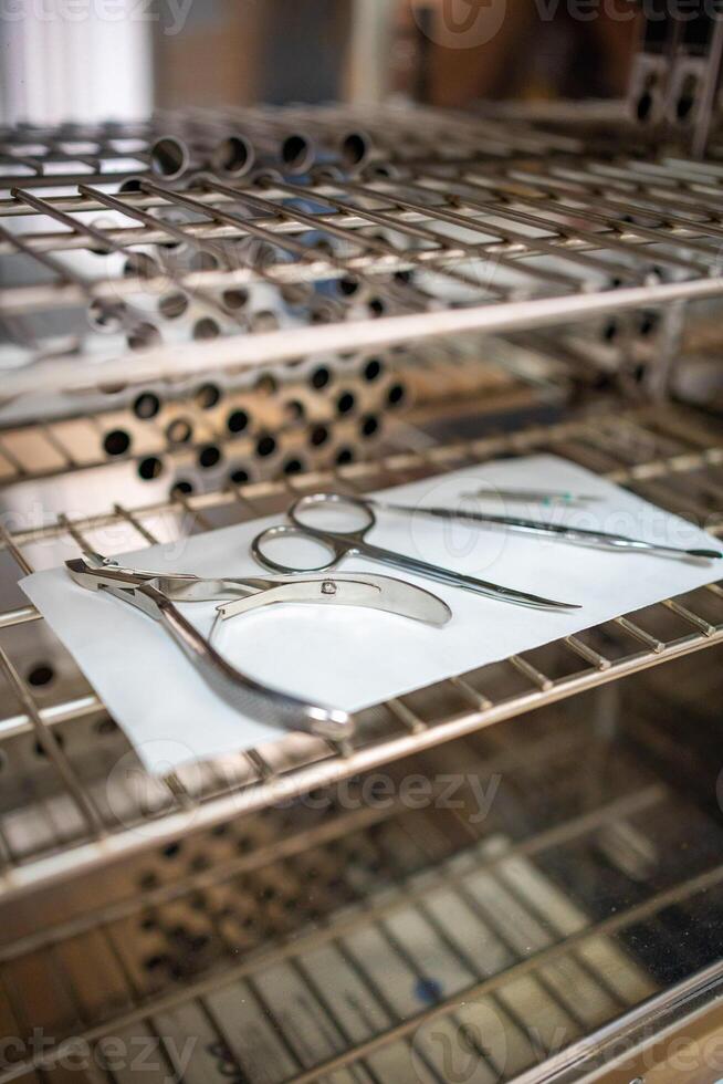 Professional disinfection of manicure tools in autoclave. Packages with tools for manicure in disinfection cabinet photo