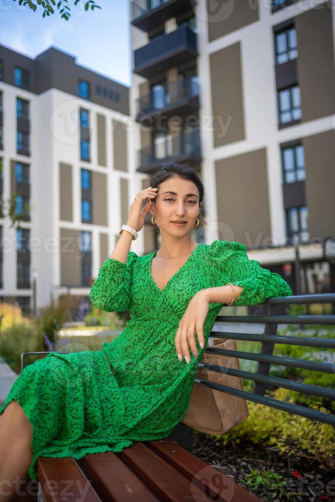 Portrait of young beautiful caucasian brown hair woman posing outdoor in the city photo