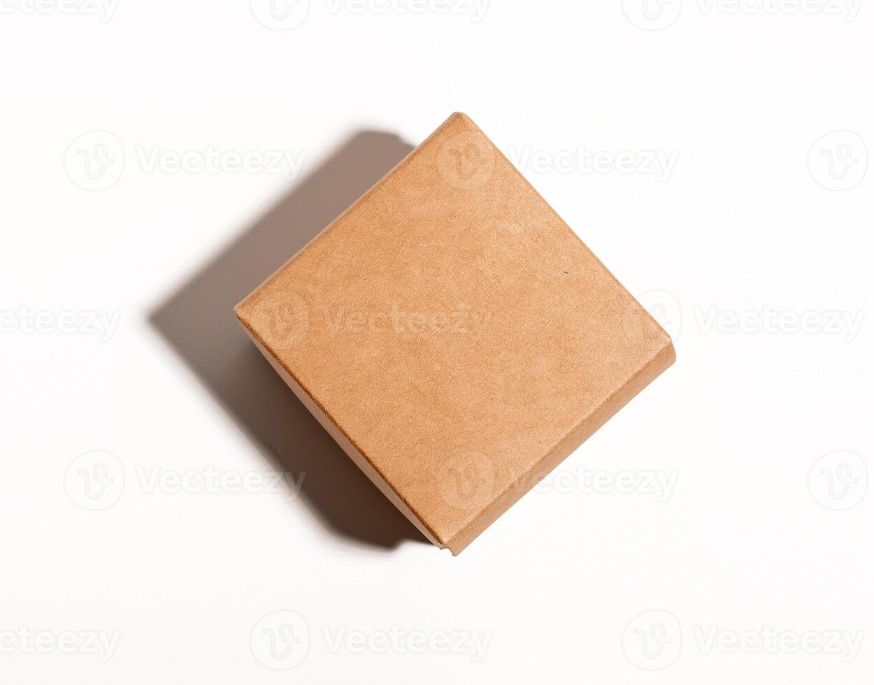 Small kraft box, square shaped package closed with lid, top view photo
