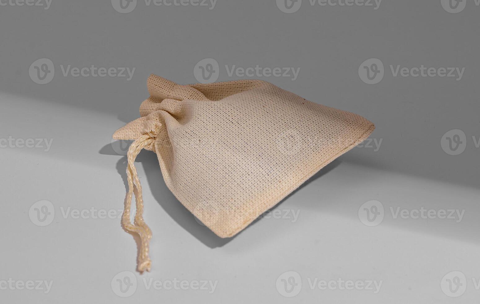 Natural textile bag, small burlap sack with strings photo