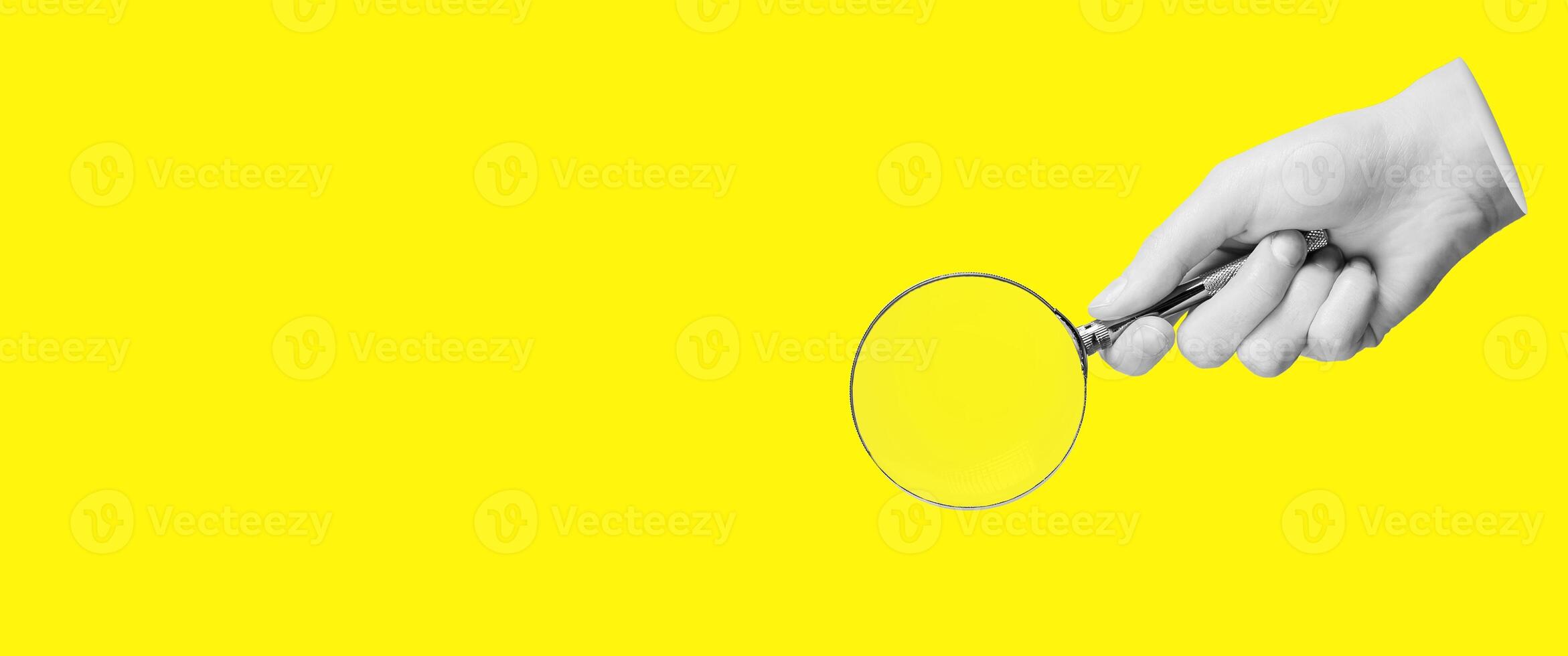 Magnifying glass, lens in hand for search, find, study, yellow banner background with copy space photo