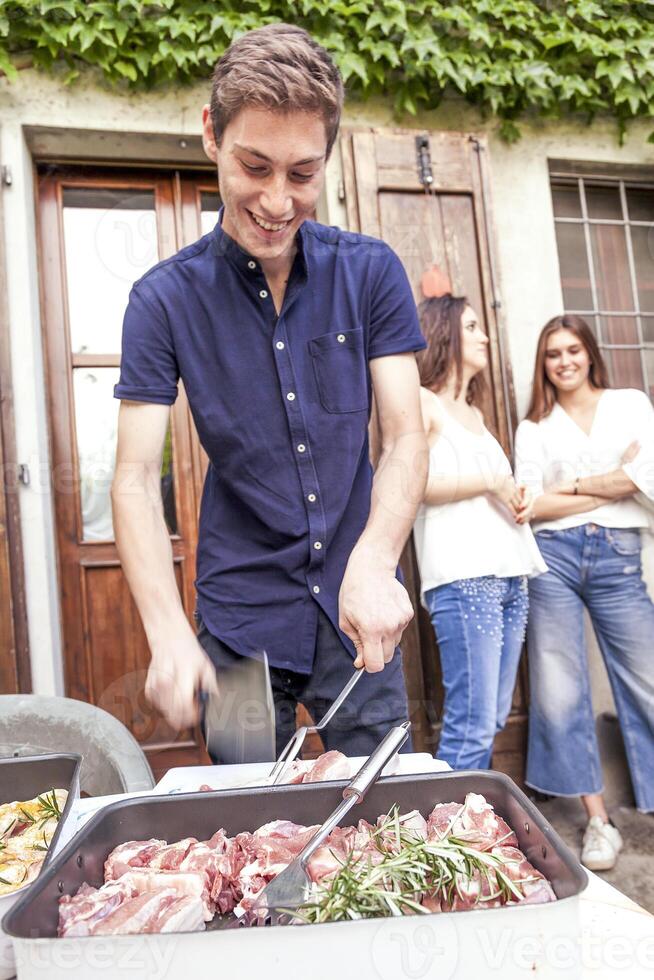 group of friends preparing a barbecue party photo