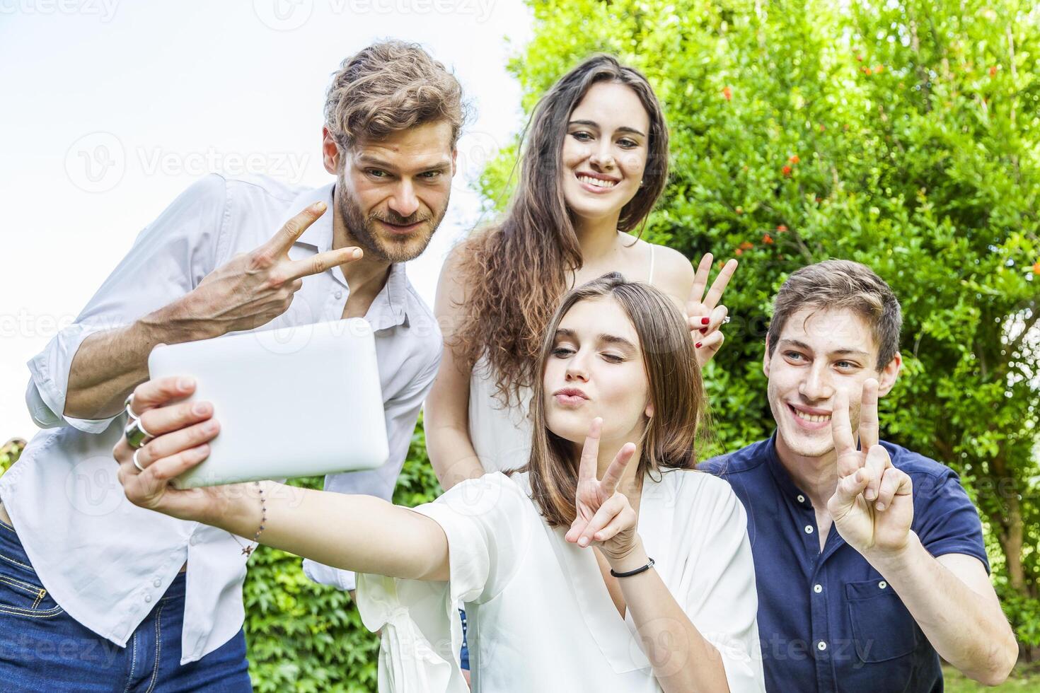 group of young friends take a selfie hugged together photo