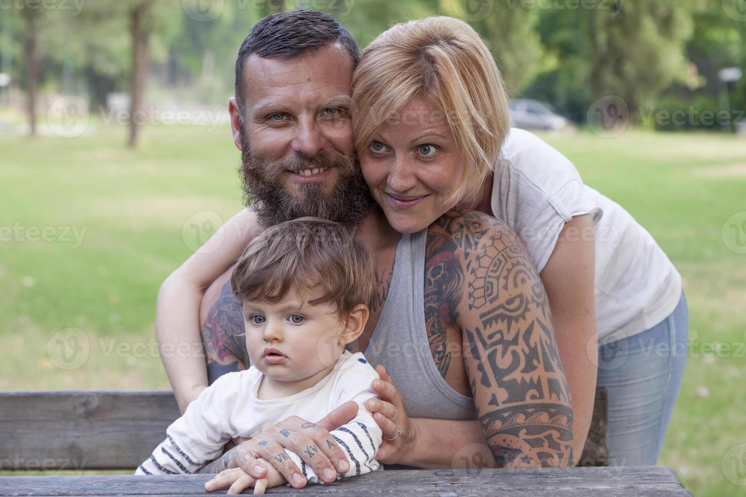 young couple with child having fun at the park photo