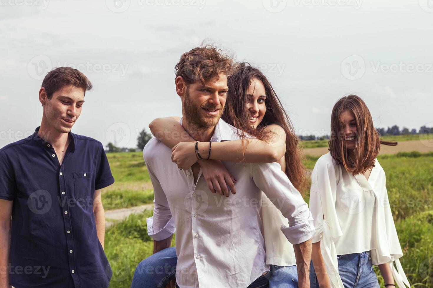 group of young handsome people walk together photo