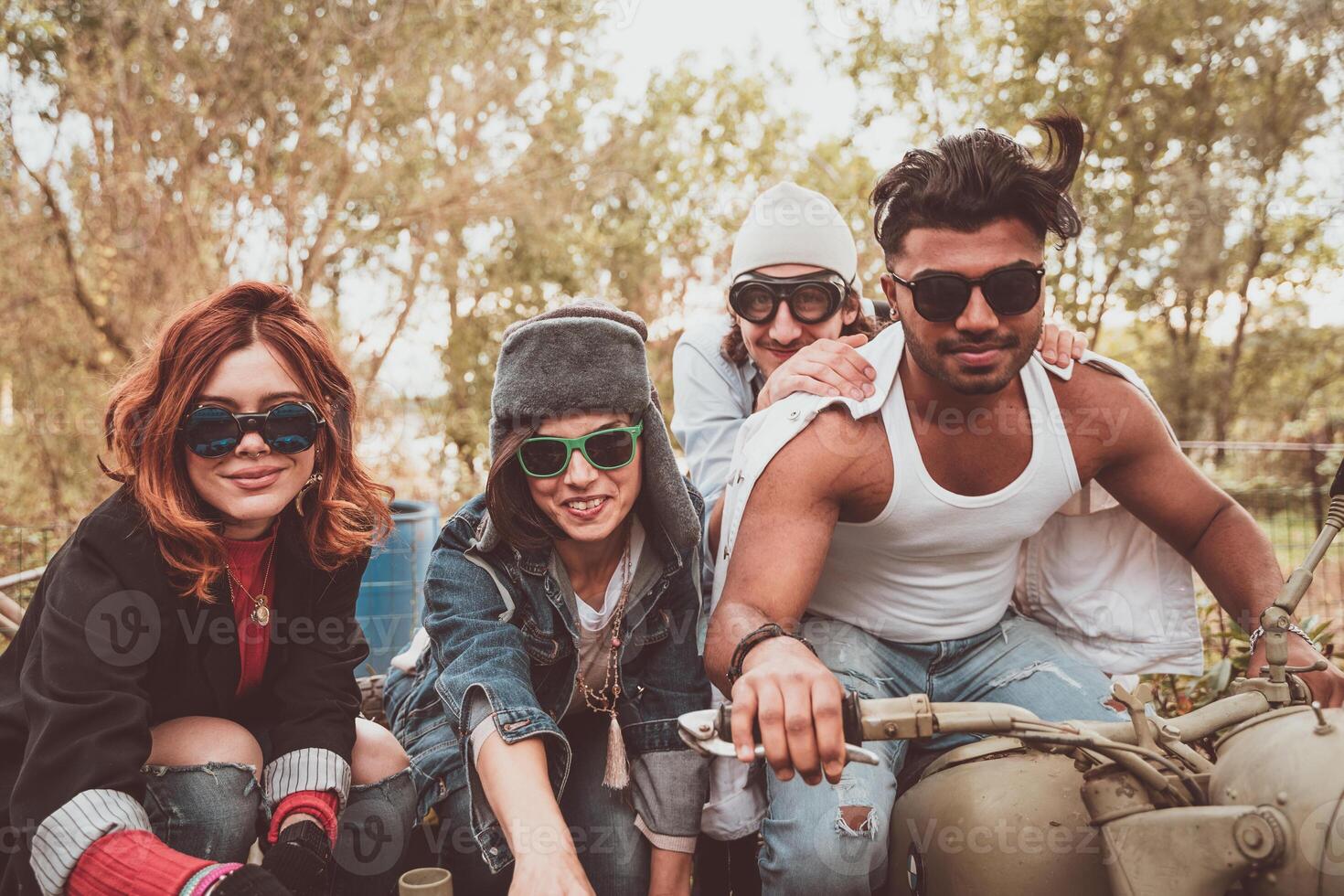 group of best friends together have fun riding a vintage motorcycle with sidecar photo