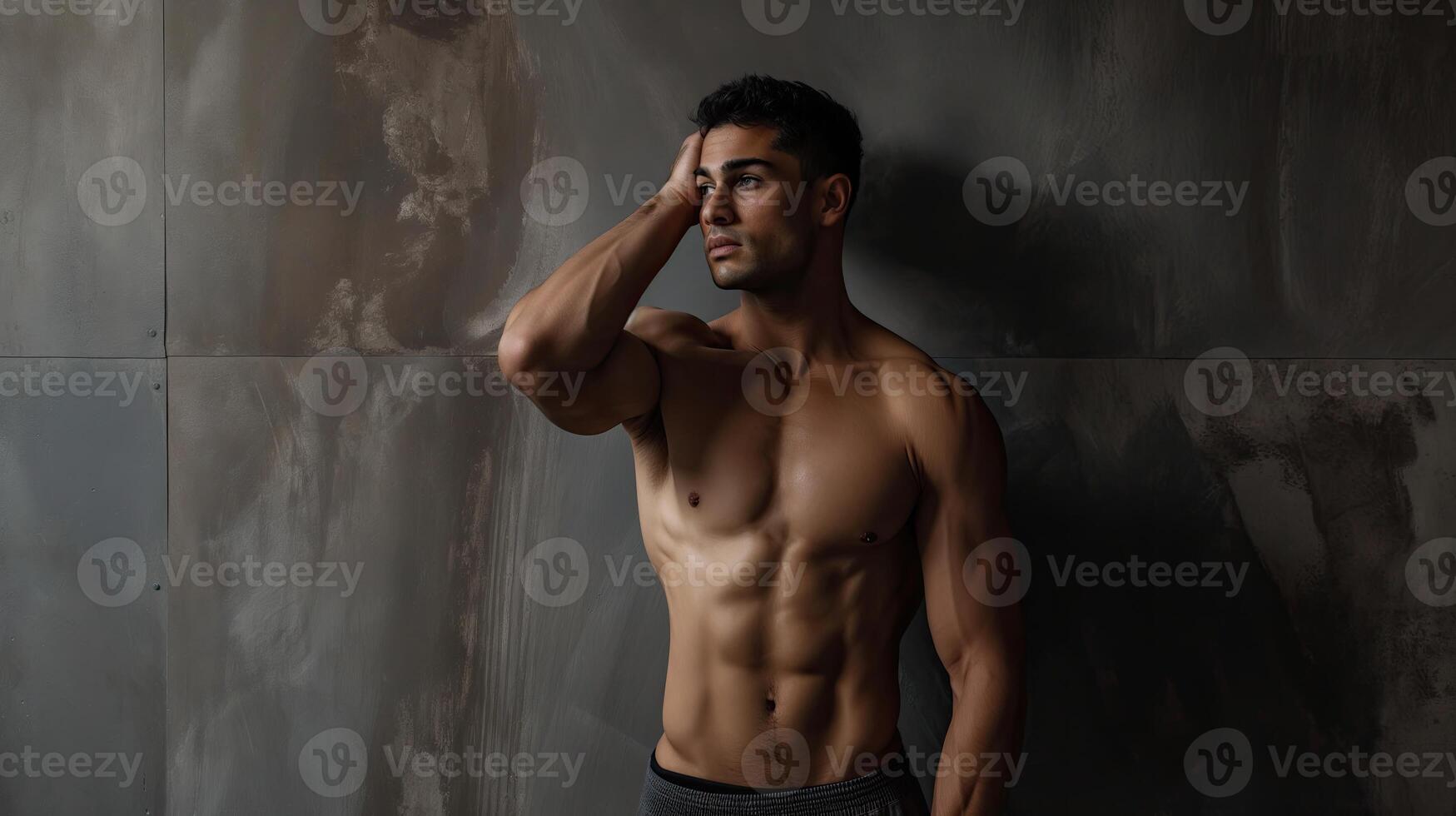 Portrait Of A Young Physically Fit Man Showing His Well Trained Body - Muscular Athletic Bodybuilder Fitness Model Posing After Exercises photo