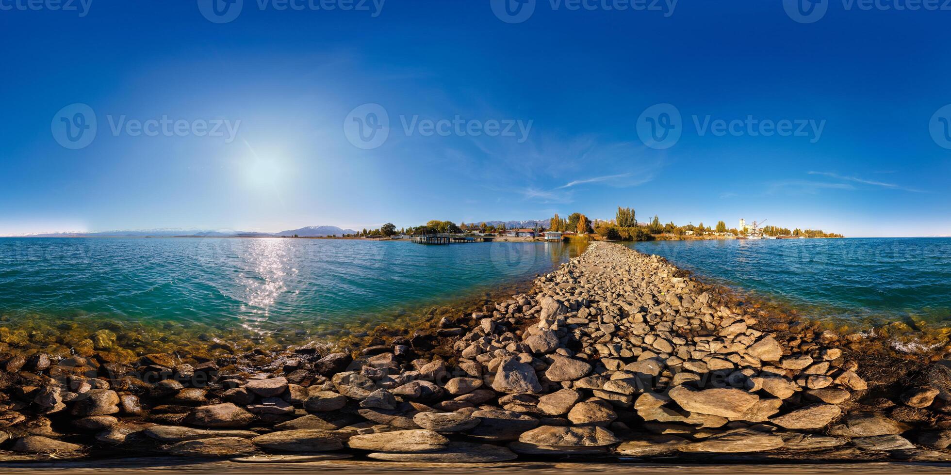 seamless 360 degree spherical panorama of breakwater cape on Issyk-Kul lake at sunny autumn day photo
