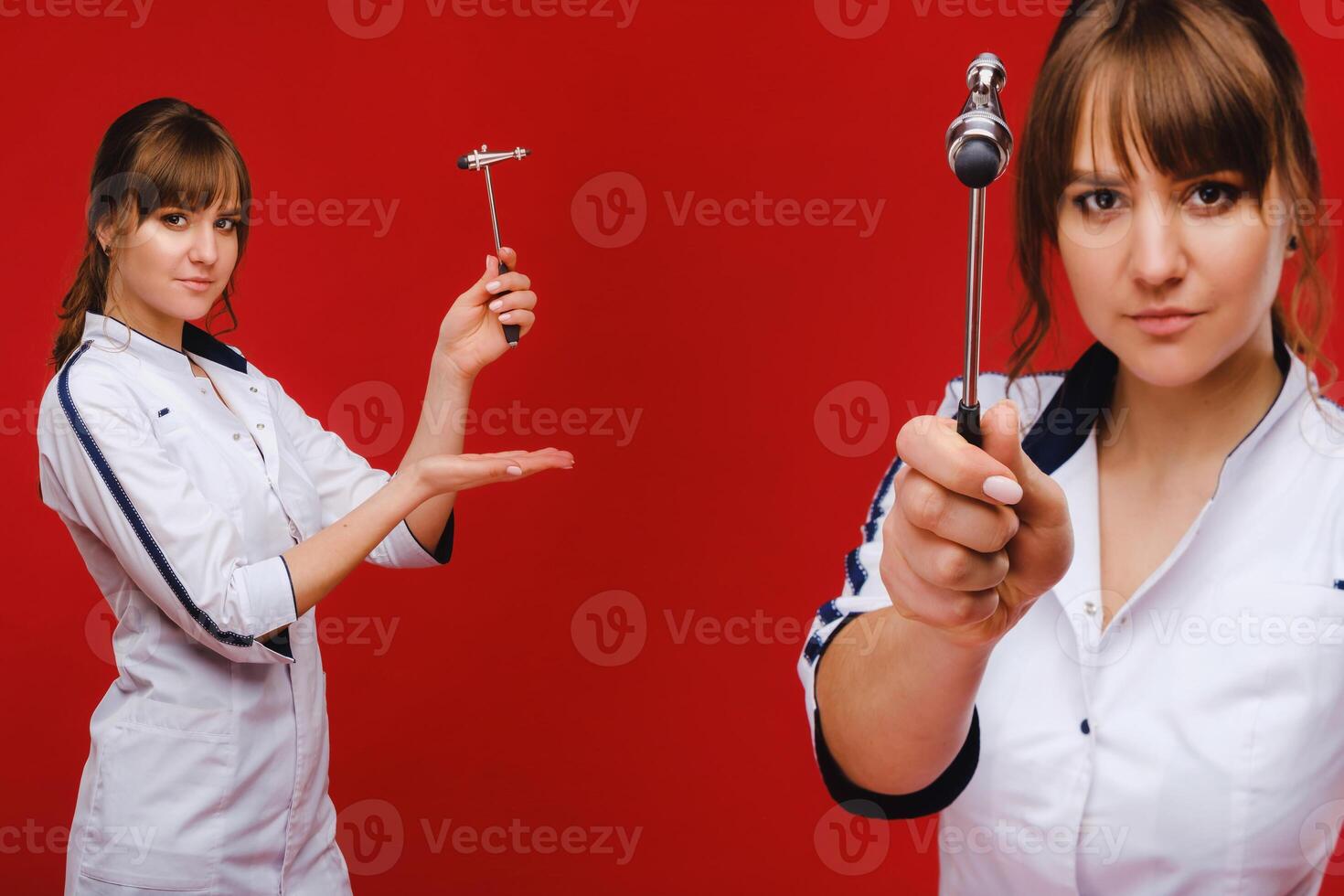 The doctor is holding a neurological hammer on a red background. The neurologist checks the patient's reflexes with a hammer. Diagnostics, healthcare, and medical care photo