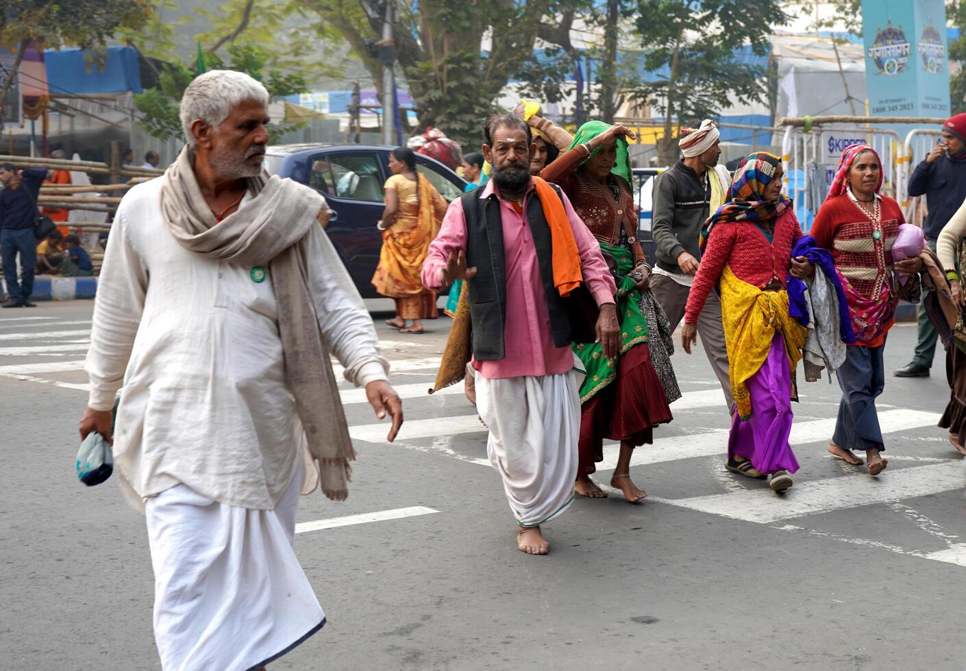 15th January 2023, Kolkata, West Bengal, India. Pilgrim from Different state crossing road during Ganga Sagar Mela at Kolkata transit Camp photo