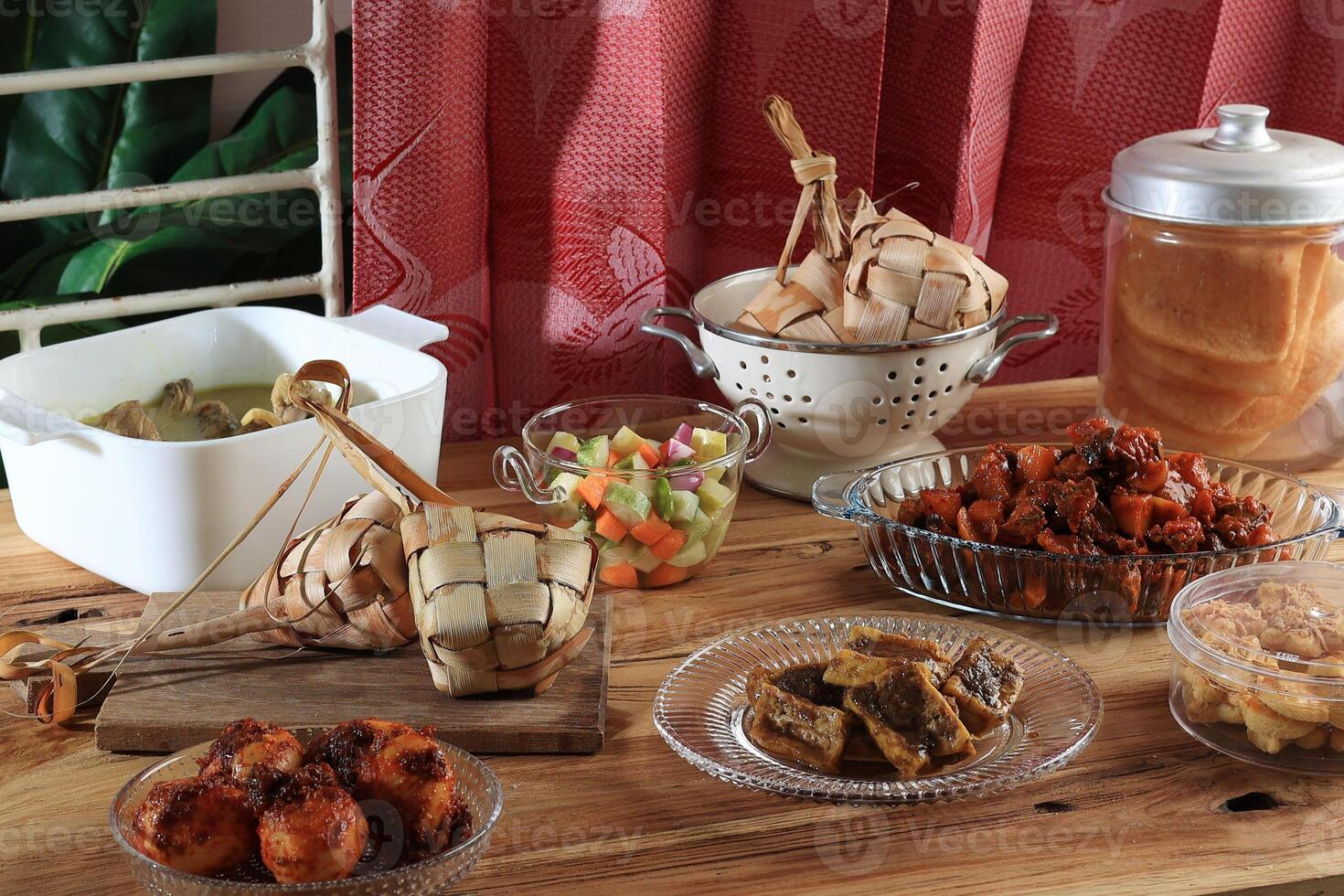 Ketupat Lebaran and Various Side Dish on the Table photo