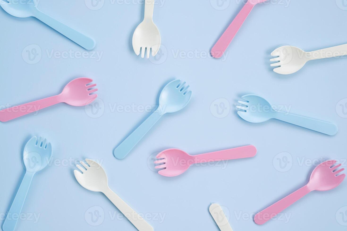 Set of kid forks lying on blue background. photo