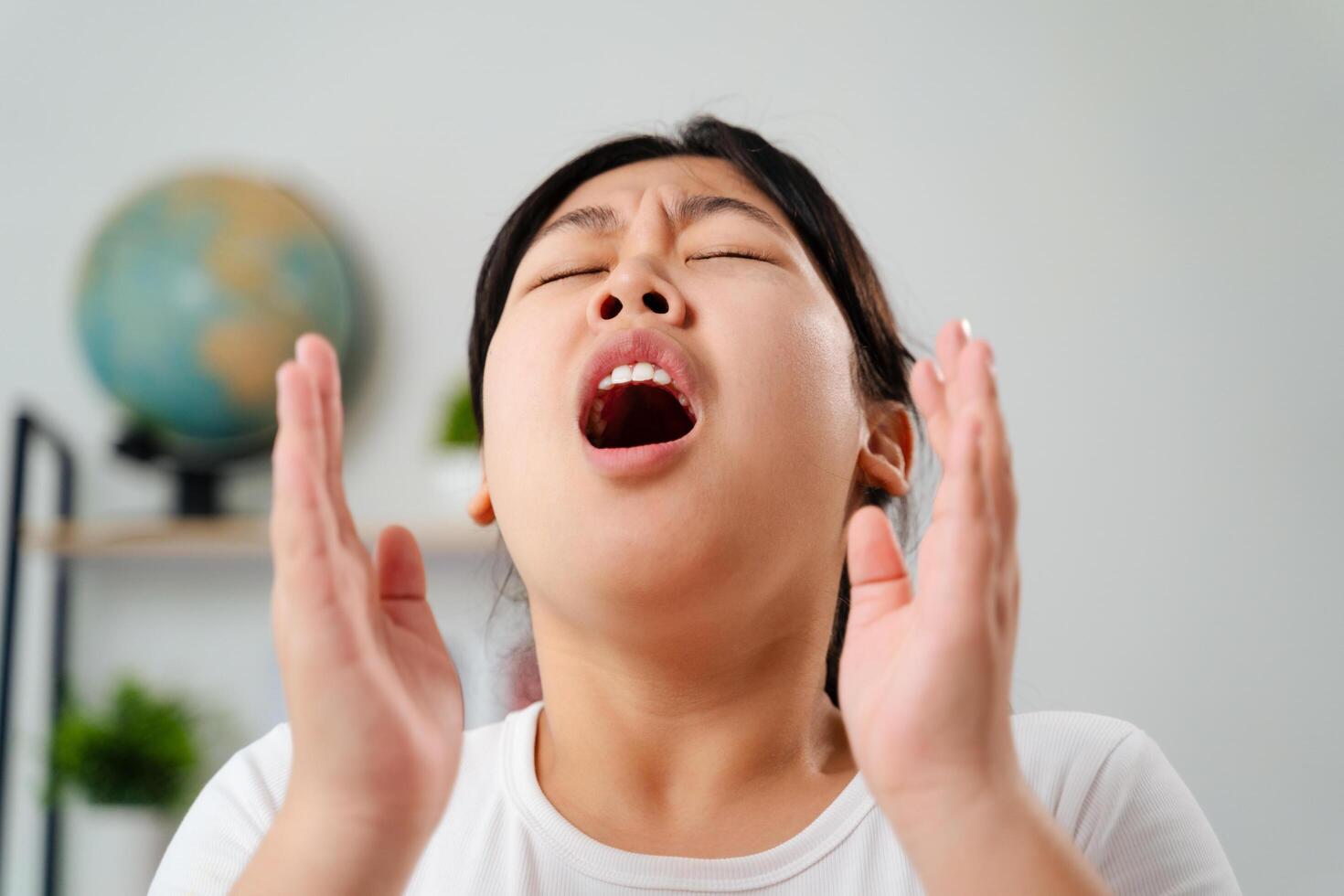 Young woman got a nose allergy sneezing sitting on the sofa at home. photo