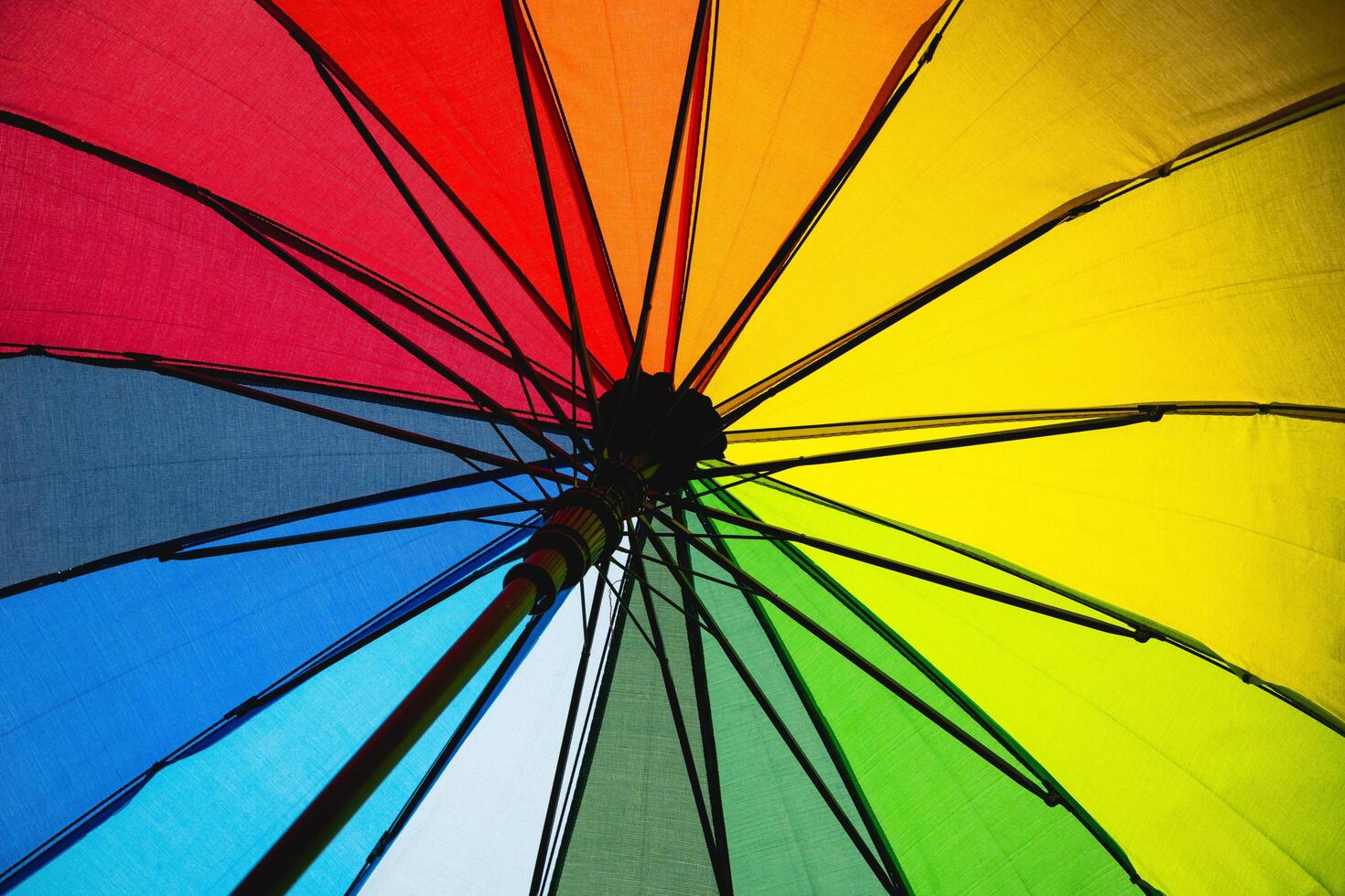 A rainbow umbrella with a black handle photo