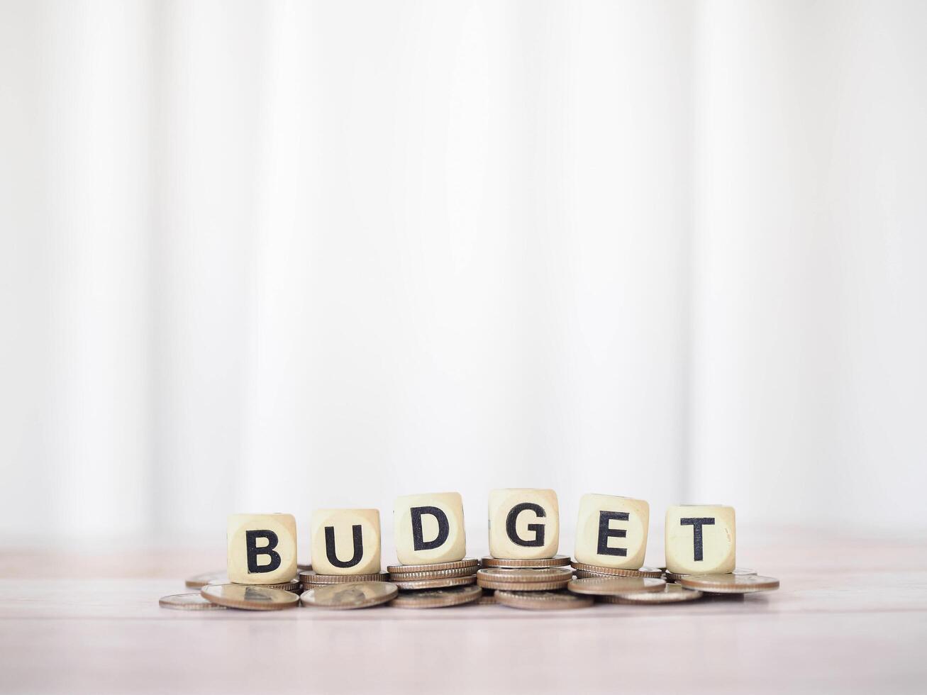 Wooden blocks with the word BUDGET on stack of coins. The concept about budget planning and allocation photo