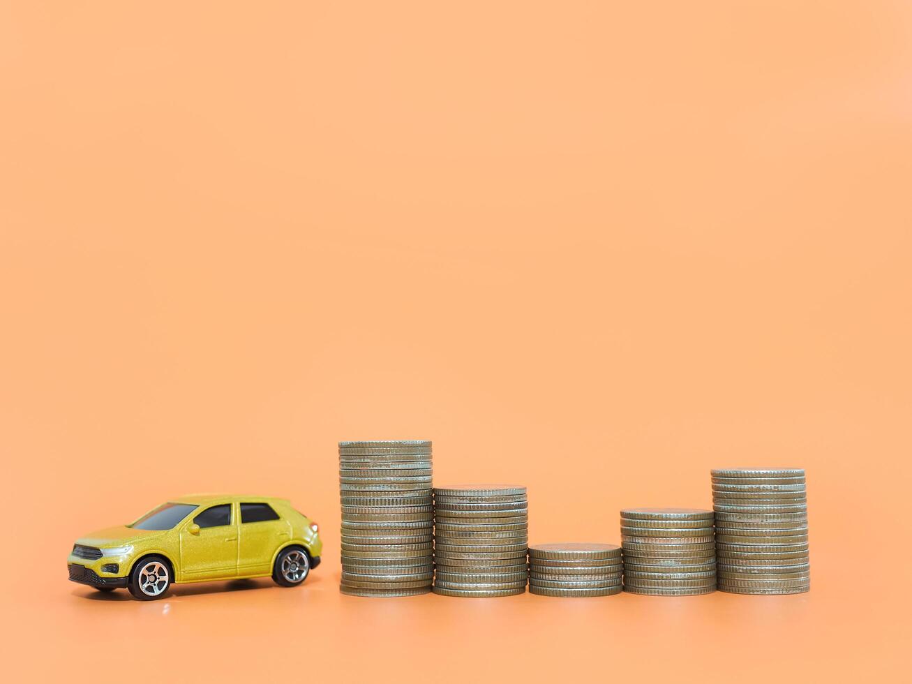 Toy car and stack of coins. The concept of saving money and manage to success transport business photo