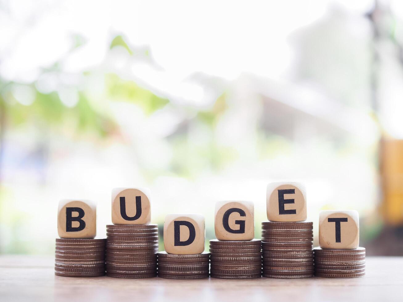 Wooden blocks with the word BUDGET on stack of coins. The concept about budget planning and allocation photo