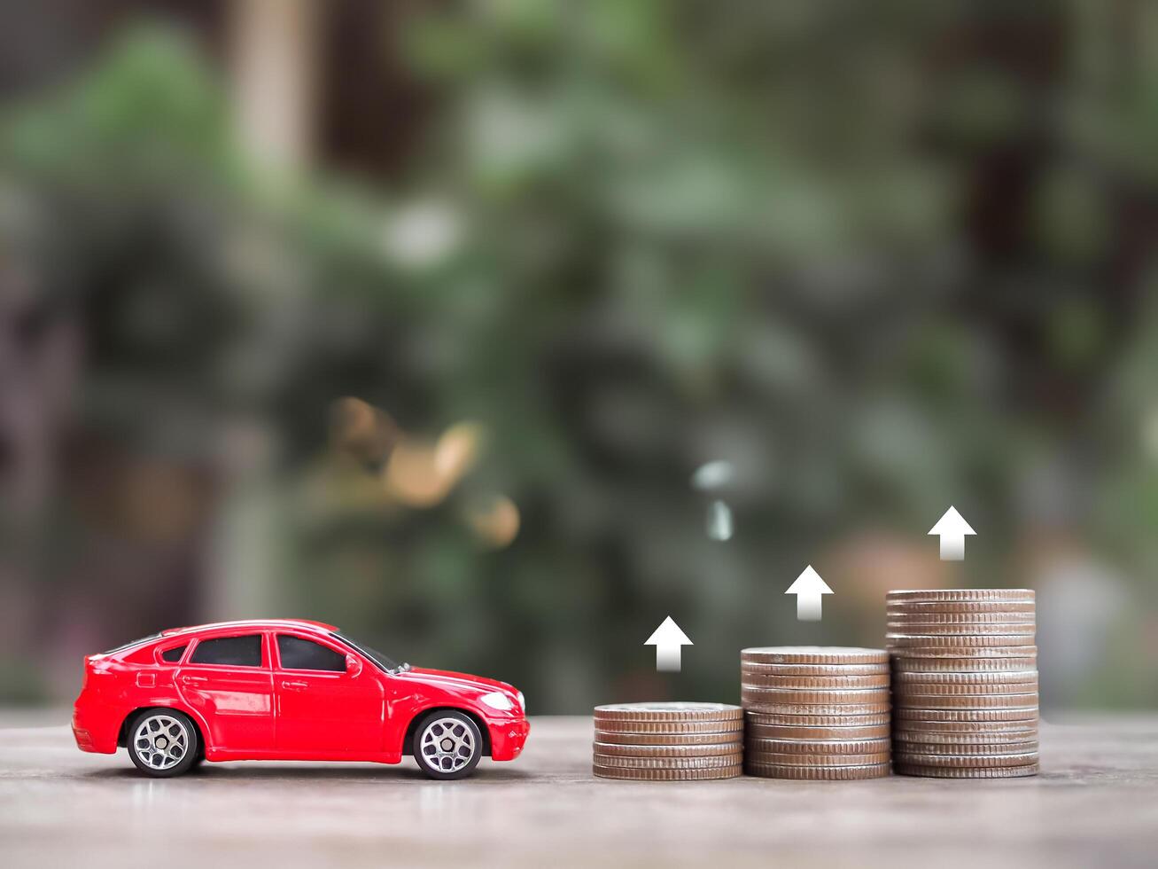 Toy car, stack of coins with arrow rising. The concept of business growth, saving money and manage to success transport business photo