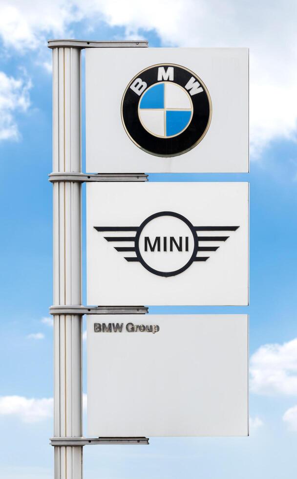 Pathumthani Thailand 23 february 2024 Logo BMW and MINI on pole with blue sky background photo