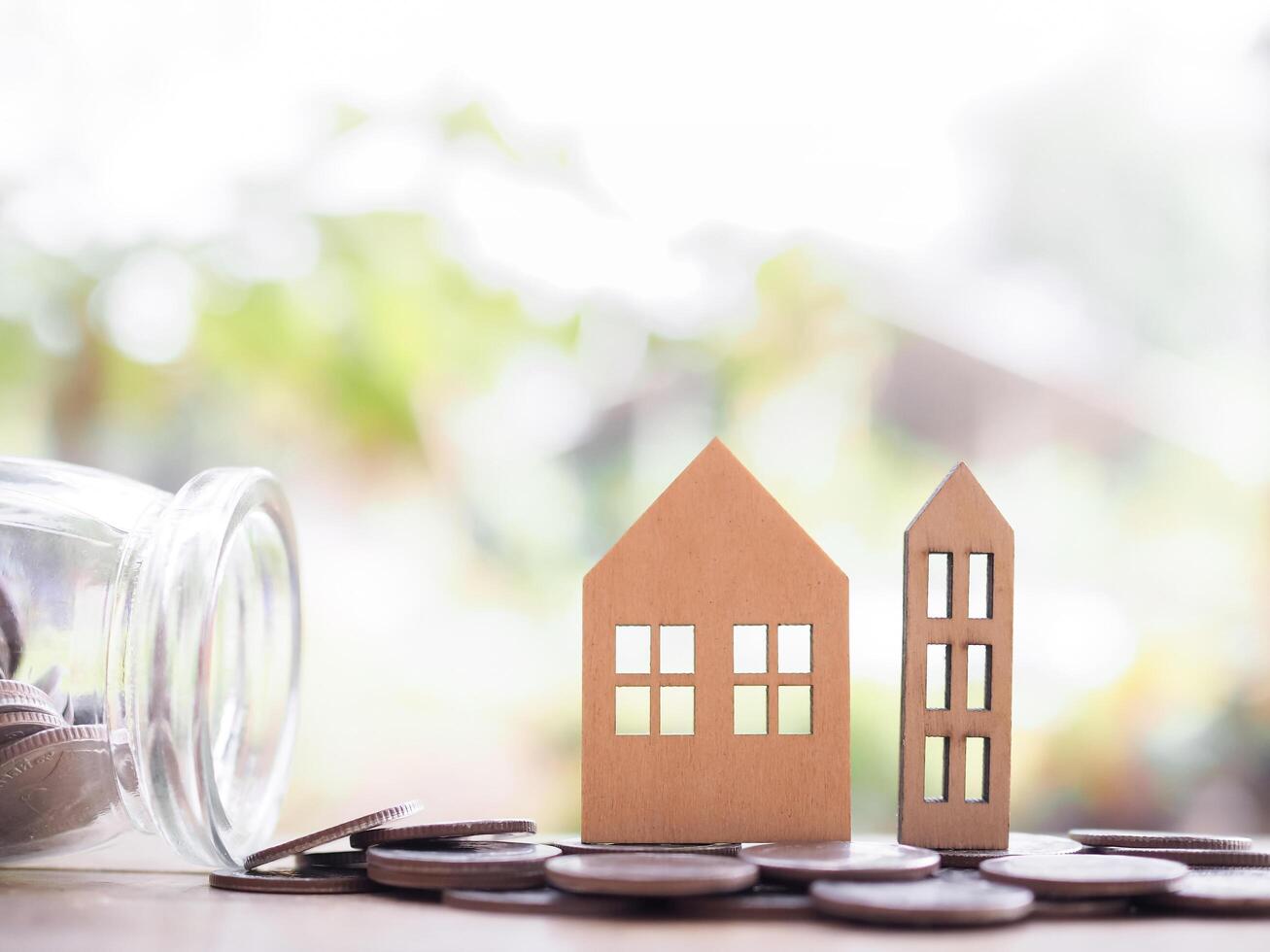 Miniature house on stack of coins. The concept of saving money for house, Property investment, House mortgage, Real estate photo