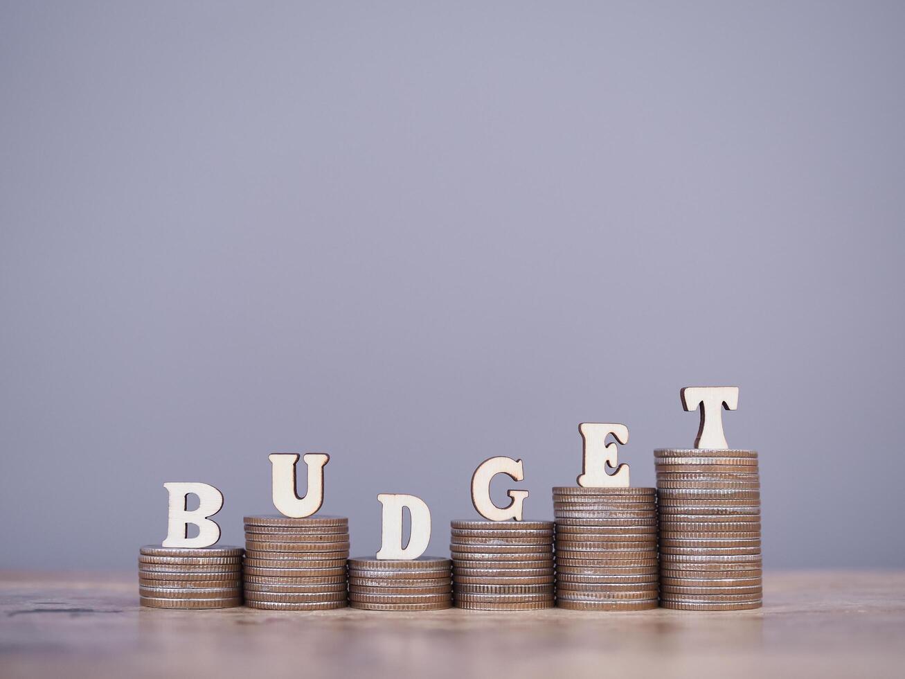 Wooden words with the BUDGET on stack of coins. The concept about budget planning and allocation photo