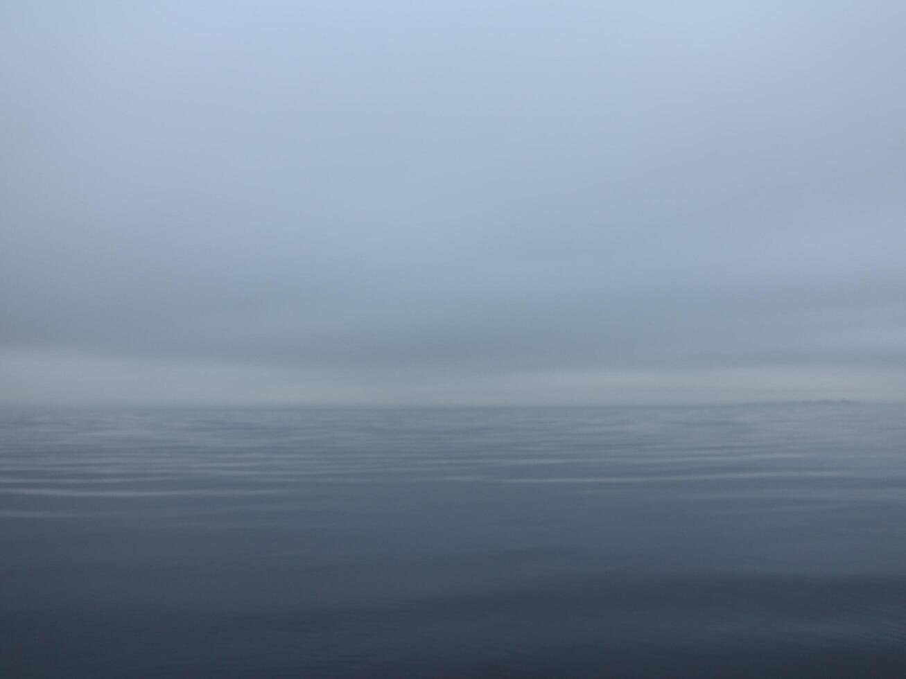 thick white fog over a calm sea, calm, silence, nothing visible, gradient background photo