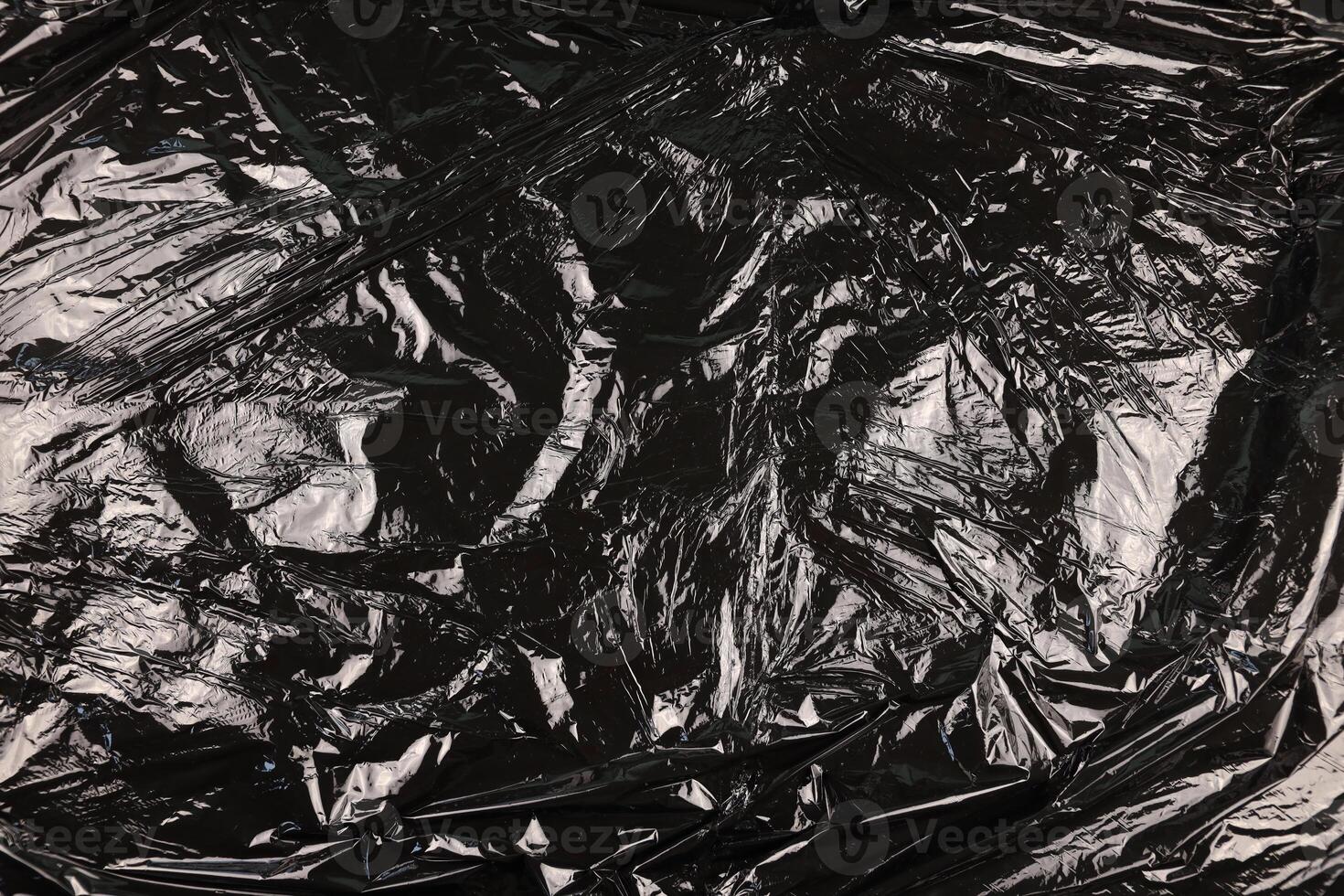 Texture of black plastic garbage disposable bag photo