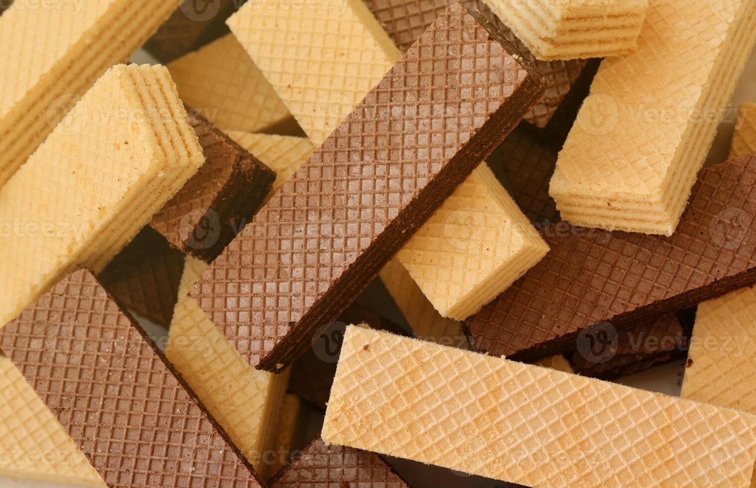Stacked delicious chocolate wafers in large amount. Two different flavours of classic waffles photo