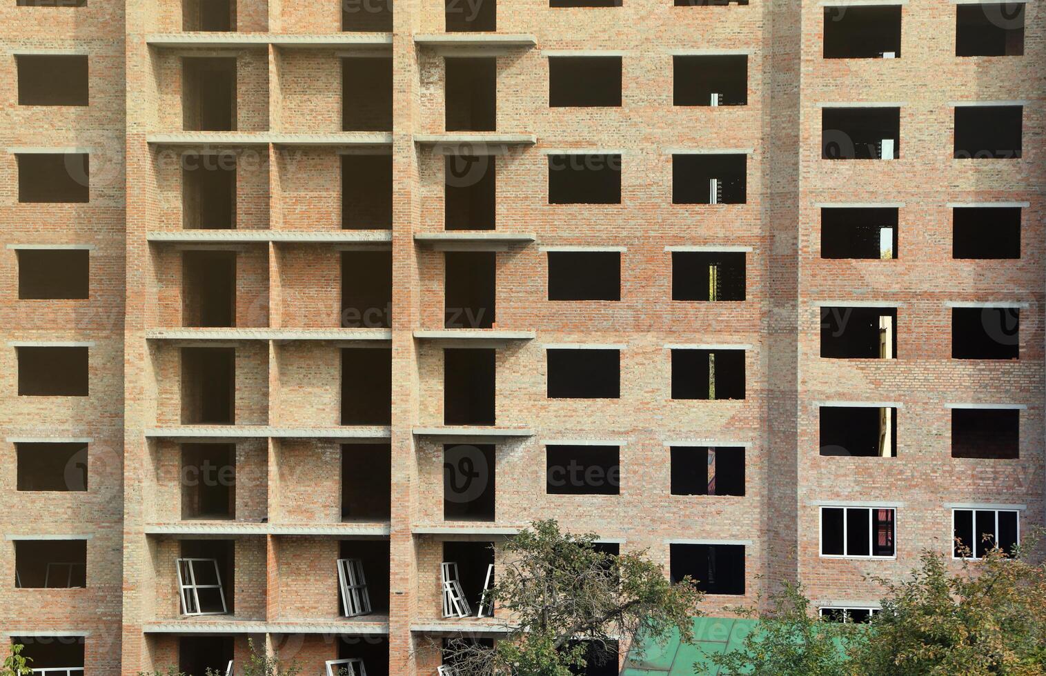 View of a large construction site with buildings under construction and multi-storey residential homes. Housing renovation photo