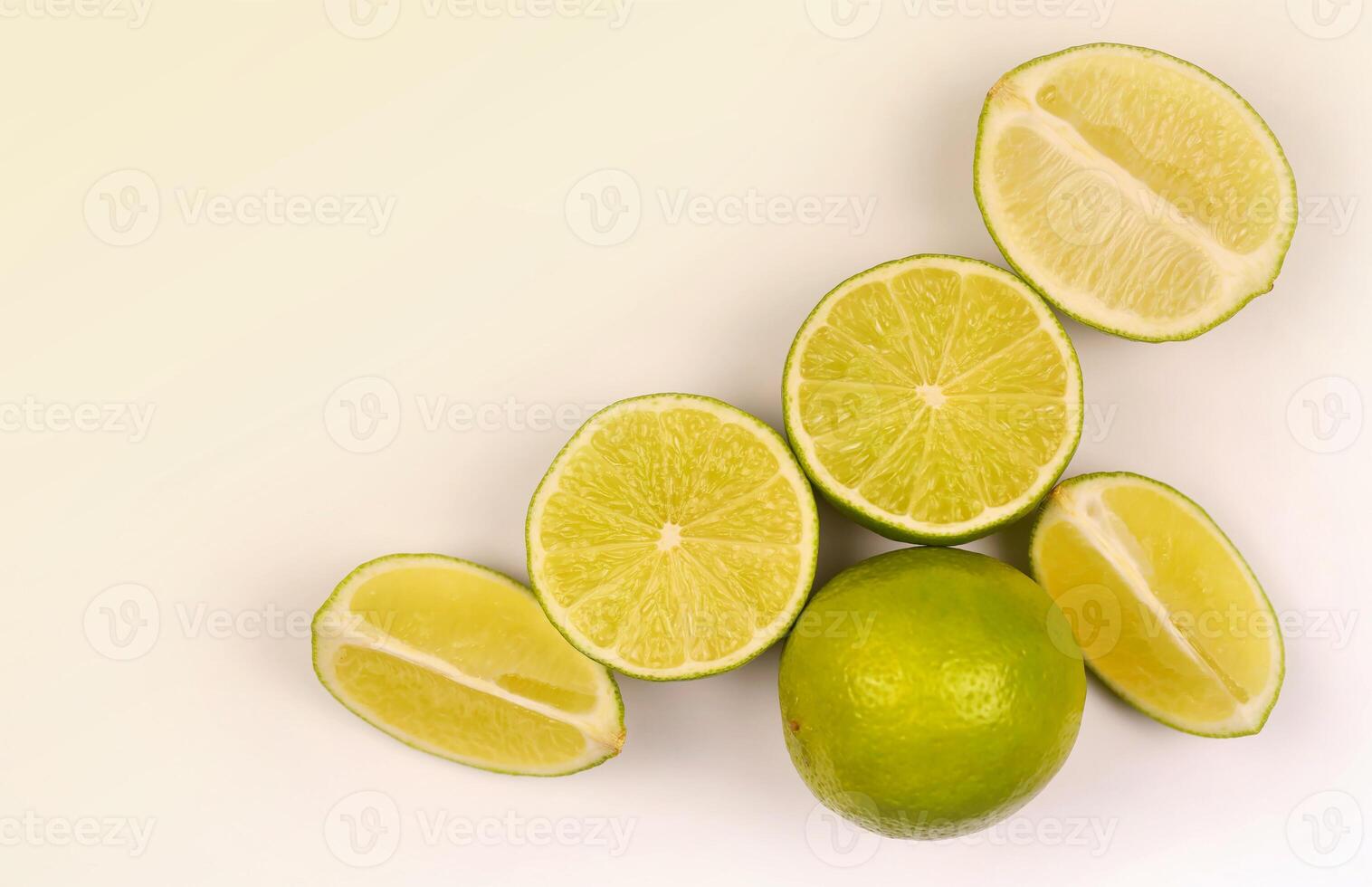 Halves or slices of green lime on light white background. Fresh fruits with copy space photo