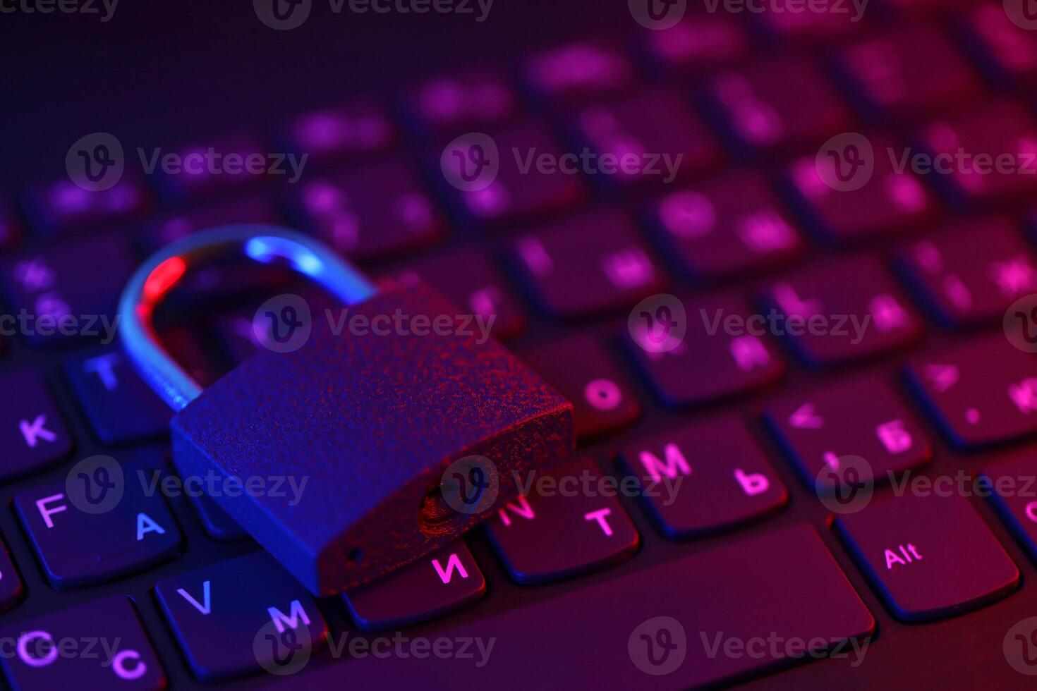 Computer security concept with a closed padlock on the keyboard. Padlock on top of a laptop keyboard. Selective focus photo