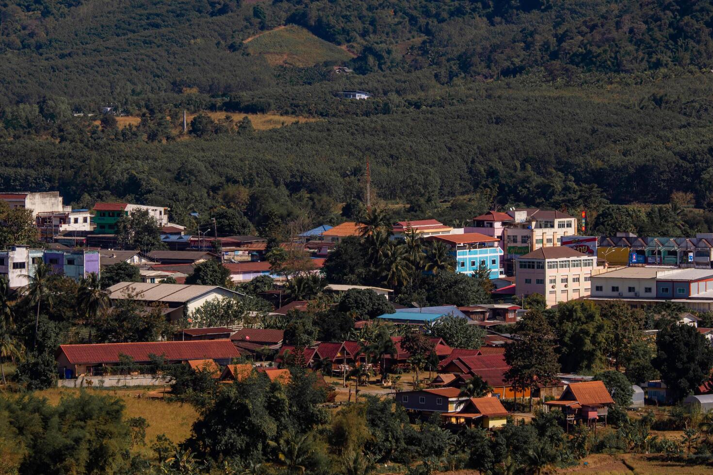 Aerial panorama, there is a well-known tourist destination with views of the mountains, village, and a farm. photo