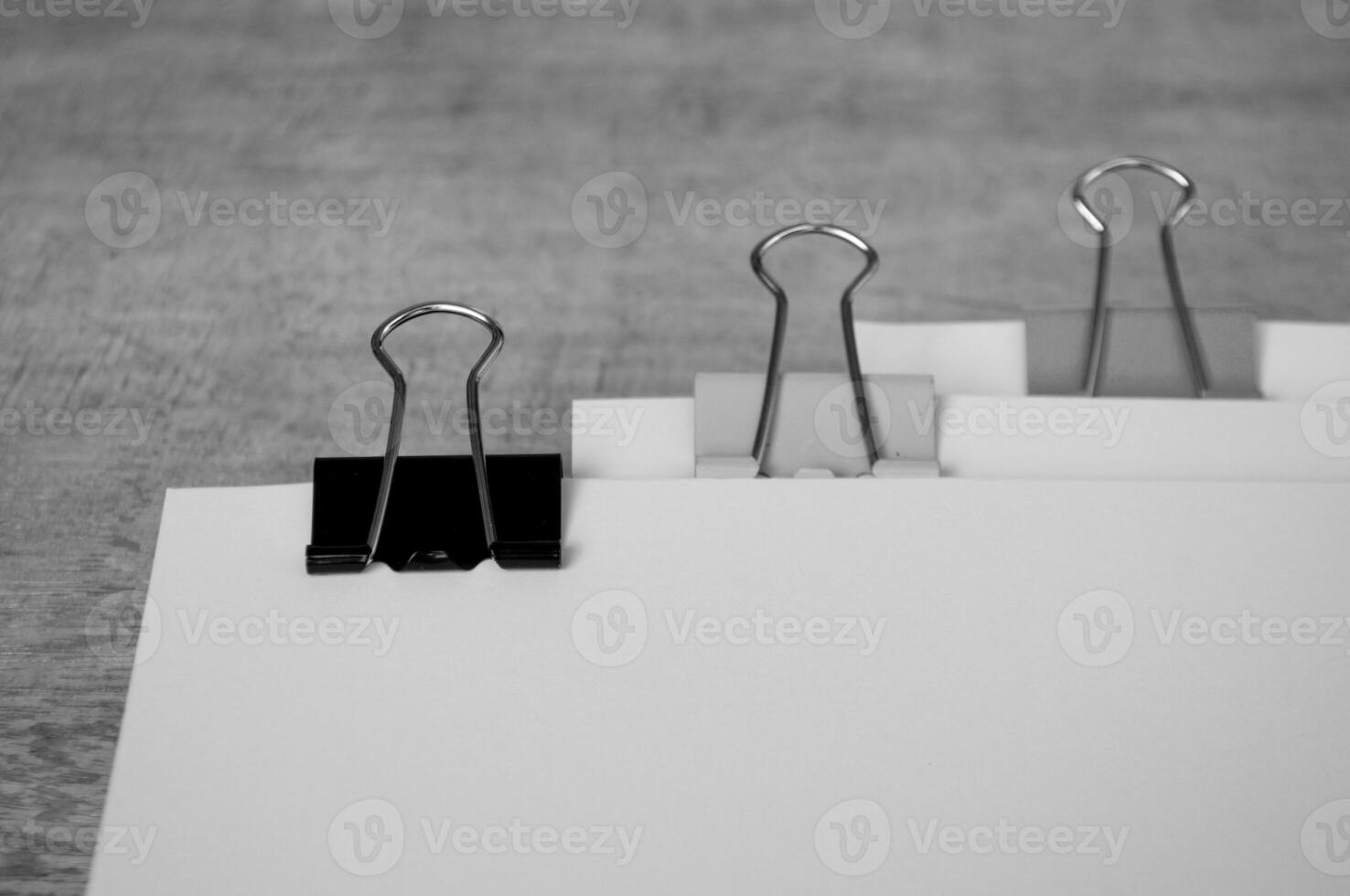 Black and white document papers with paper clips pastel on wooden table photo