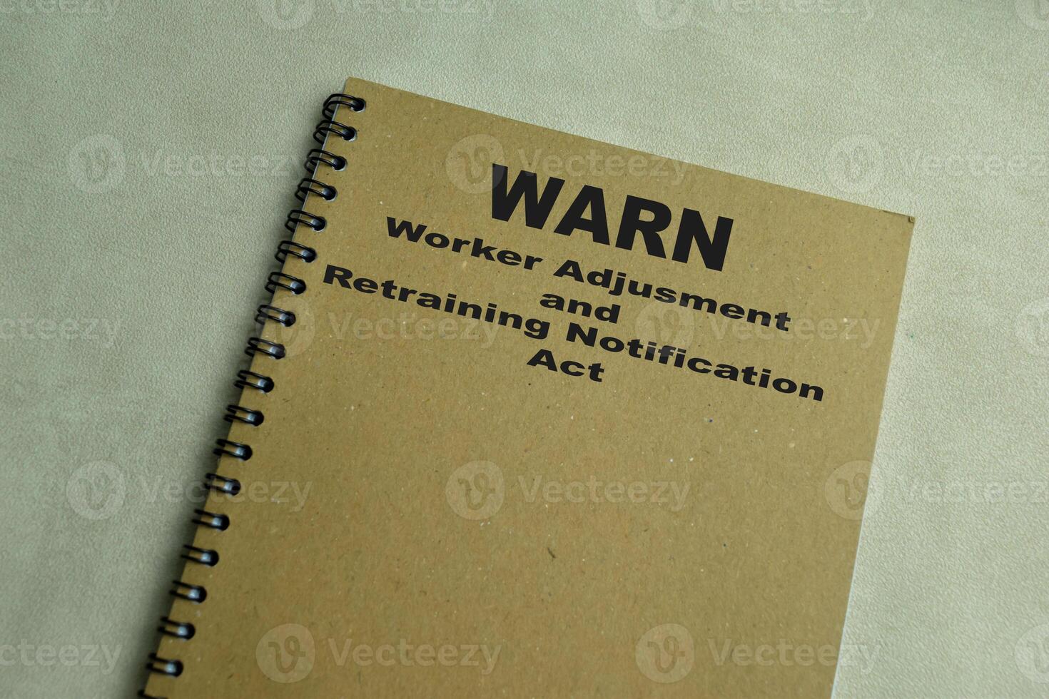 Concept of WARN - Worker Adjusment and Retraining Notification Act write on book isolated on Wooden Table. photo
