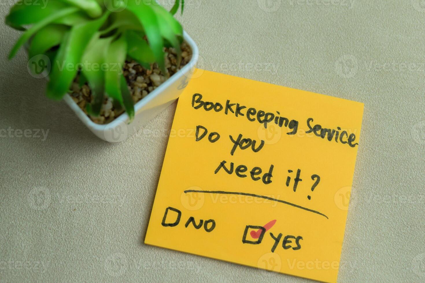 Concept of Bookkeeping Service, Do You Need it write on sticky notes isolated on Wooden Table. photo