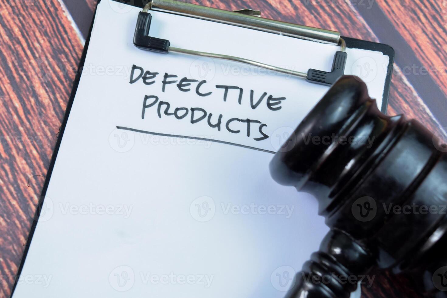 Concept of Defective Product write on paperwork with gavel isolated on wooden background. photo