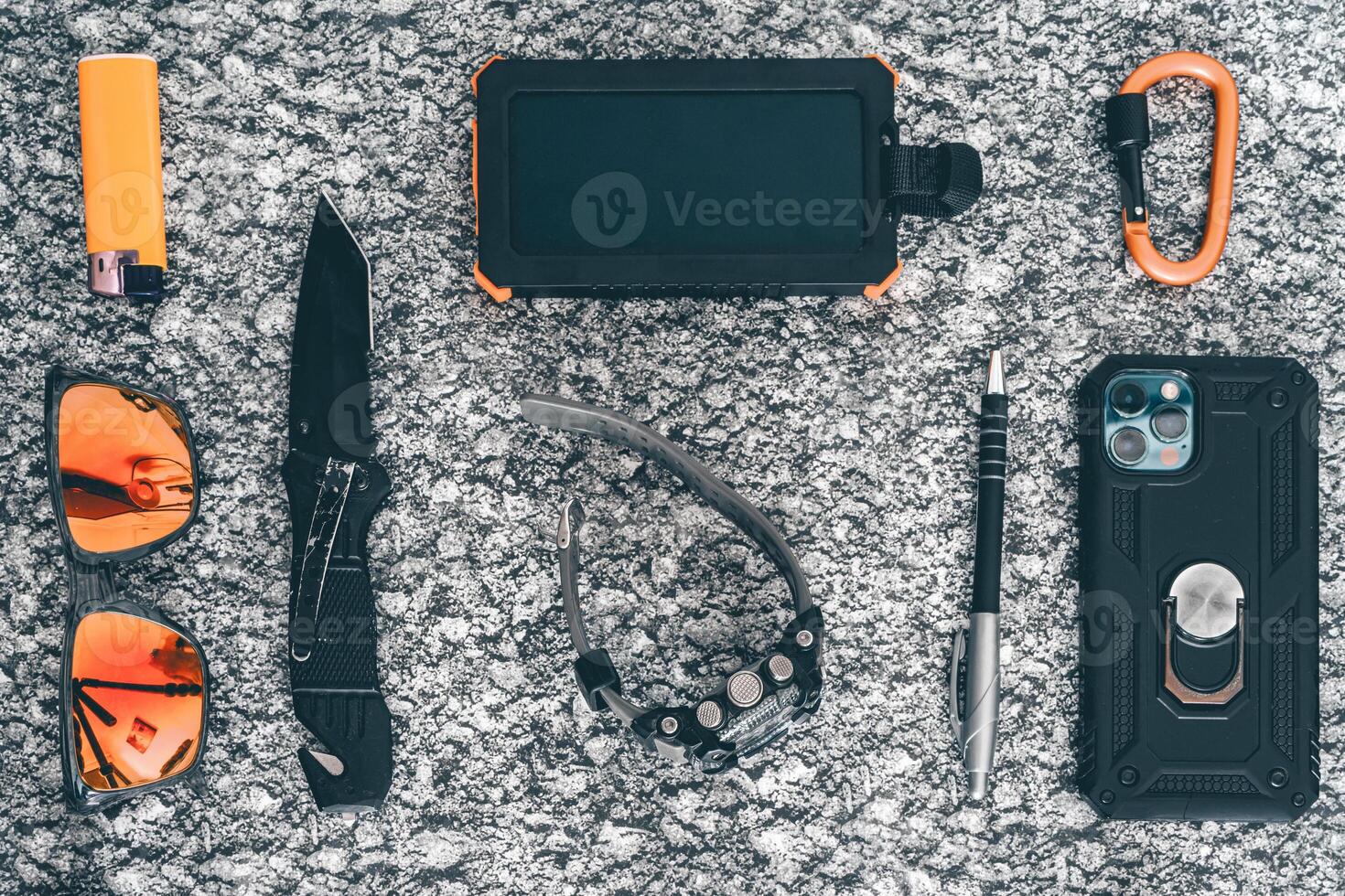 Flat lay of some Outdoor EDC gear on a grey background. photo