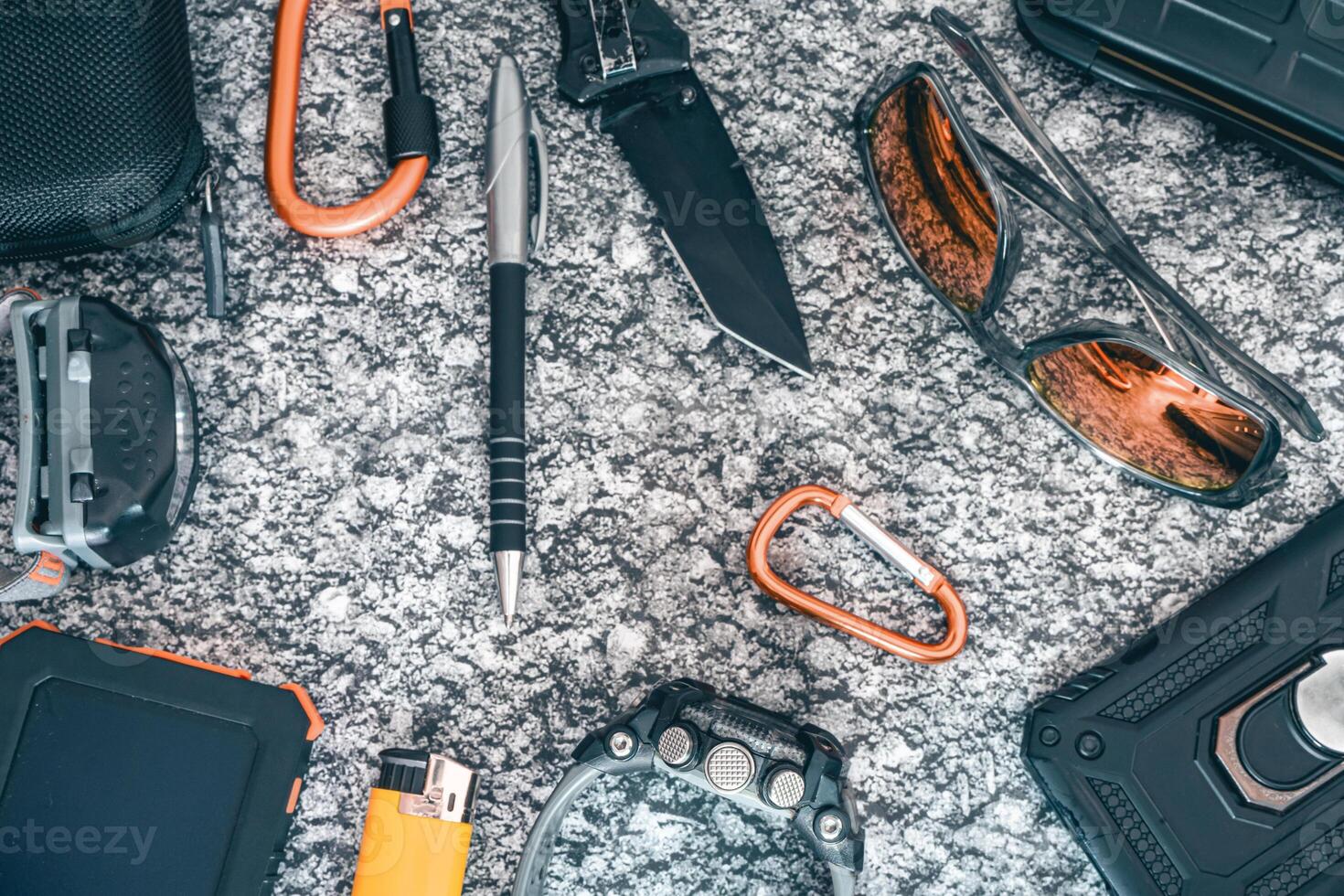 Flat lay of some Outdoor EDC gear on a grey background. photo